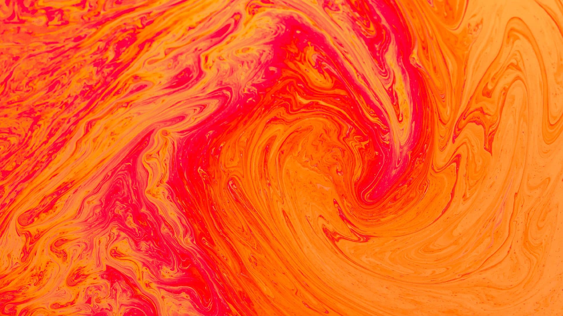 a close up of a red and orange swirl .