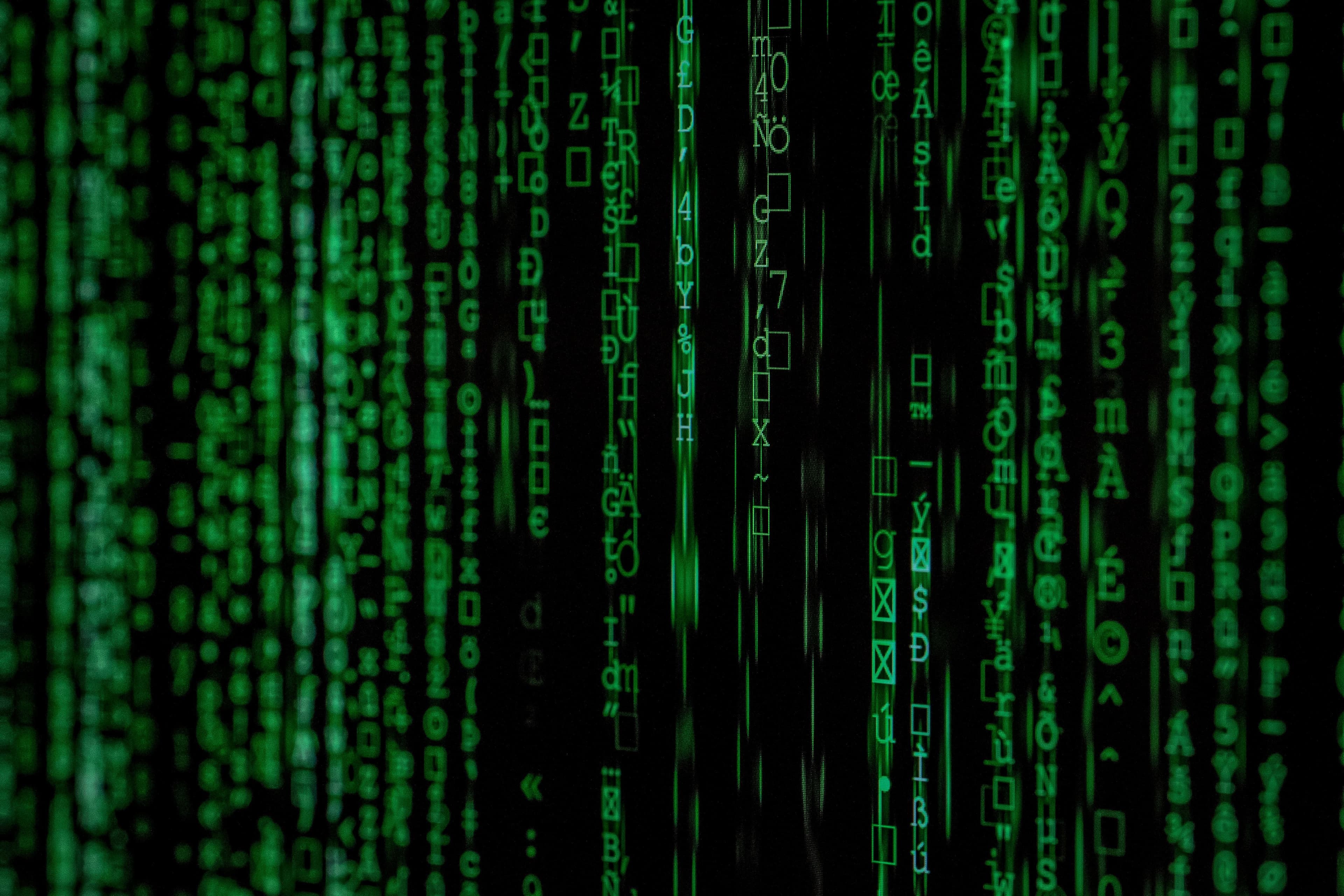 a close up of a green matrix code on a black background .