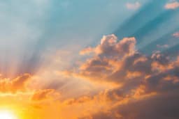 the sun is shining through the clouds at sunset .