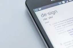 a close up of a cell phone with the word design on the screen .